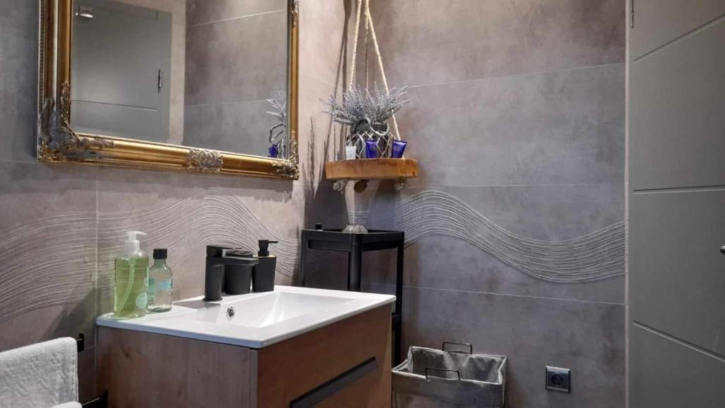 a bathroom with a sink and a mirror at SMOKVICA in Savudrija