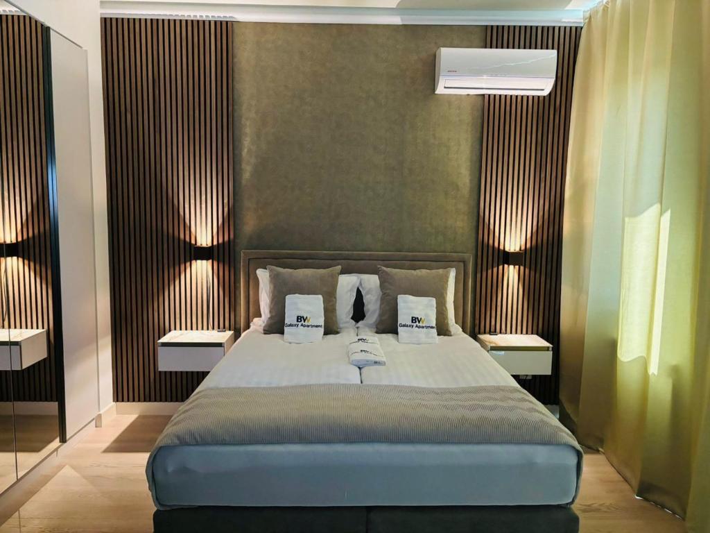 a bedroom with a large bed with two lamps at Belgrade Waterfront-Beograd na vodi Galaxy Apartment in Belgrade
