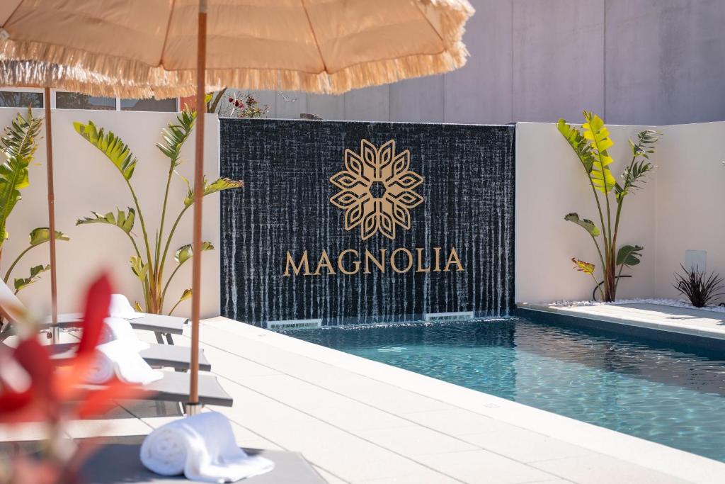 un cartello che dice "Macaulla" vicino alla piscina. di Magnolia Luxury Villa a Vieira de Leiria