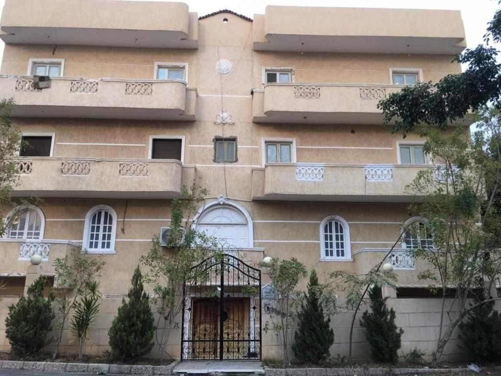 a building with balconies on the side of it at غرفه فندقيه للإيجار ( فيلا الاسعد ) امام مول العرب in 6th Of October