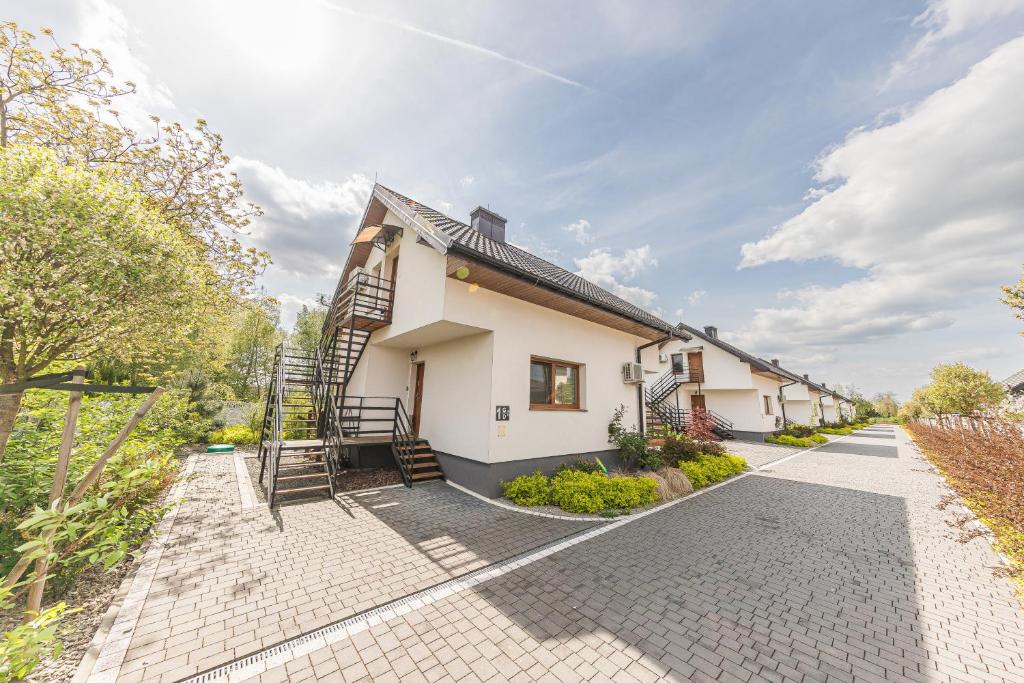 a house with a staircase on the side of it at Lider House Energy in Smolice