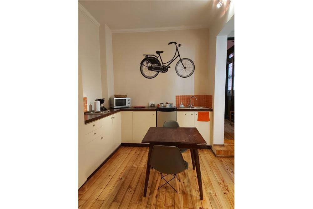 a bike hanging on the wall in a kitchen at APARTHOTEL POVIDENCIA Santiago in Santiago