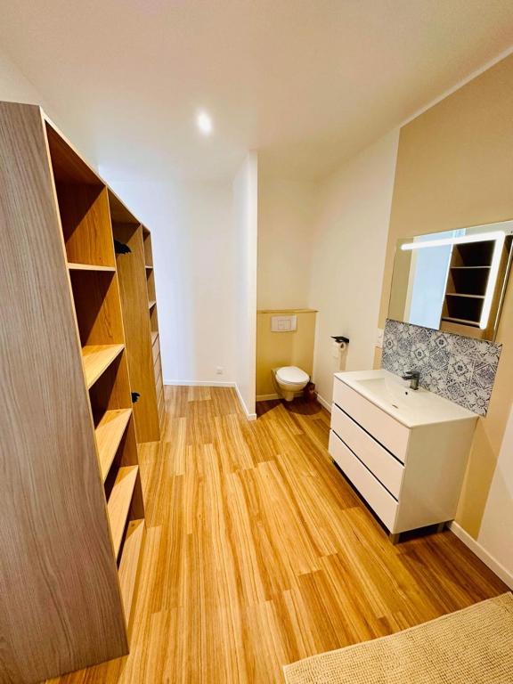 une salle de bain avec un lavabo et des toilettes dans une chambre dans l'établissement Maison de ville, à Barbezieux-Saint-Hilaire