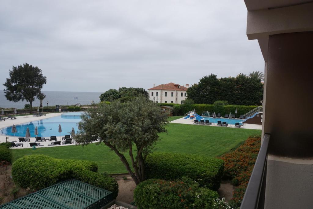 a view of a swimming pool and a resort at Apartamento Villa Galé Cascais in Cascais