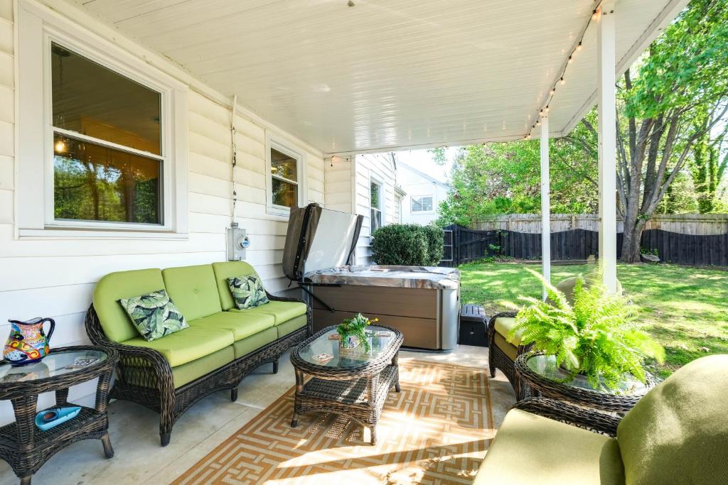 a porch with a couch and chairs and a table at Colorful Roanoke Vacation Rental with Hot Tub! in Roanoke