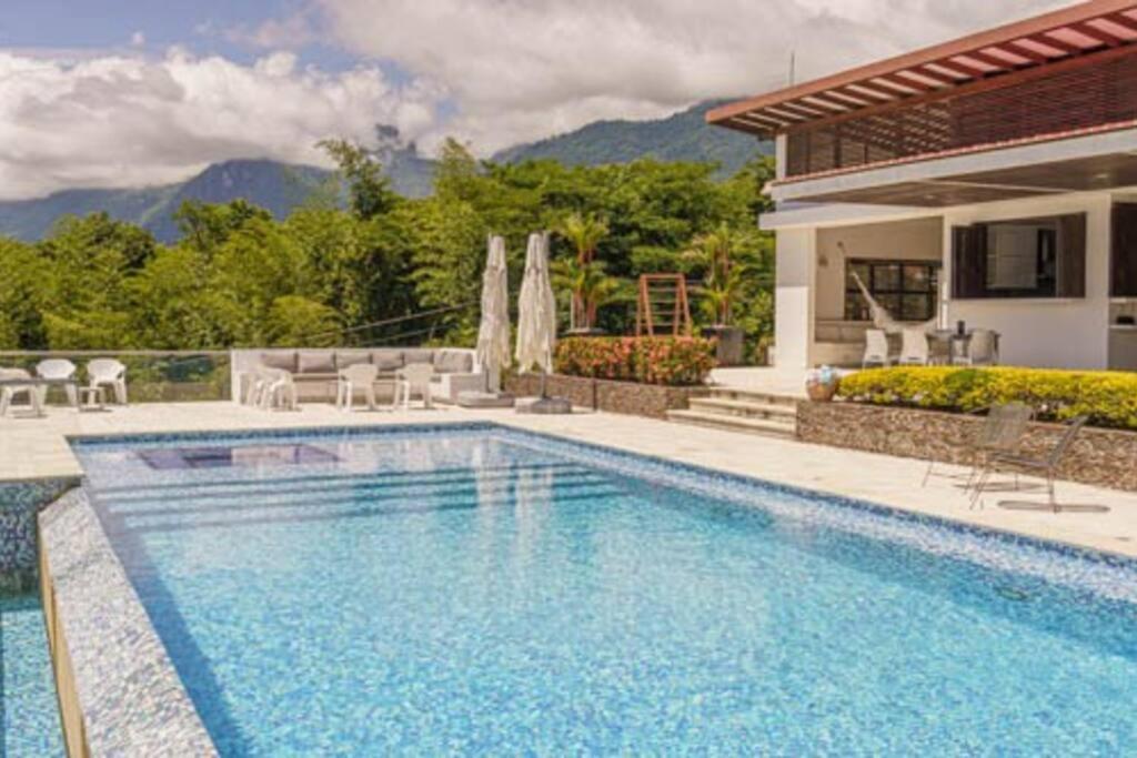 a swimming pool in front of a house at Balmoral House With Pool & Jacuzzi in La Pintada