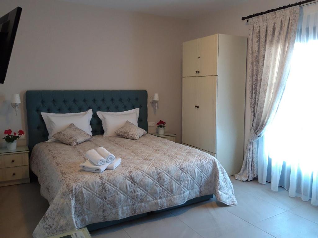 a bedroom with a bed with two towels on it at Pansion Irini in Ouranoupoli