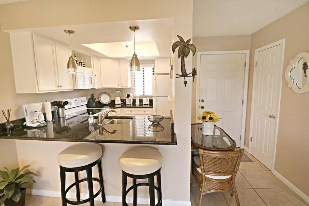 a kitchen with a counter and a table with stools at Beach Side complex B23 1 Bed 1 Bath w/Heated Pool in Saint Augustine