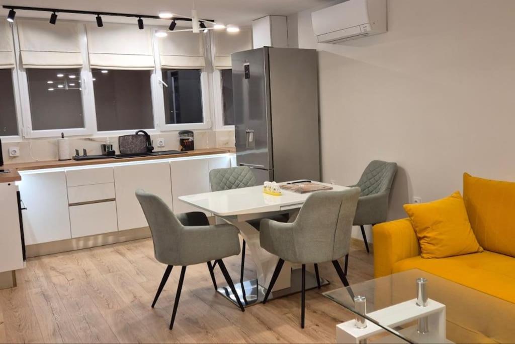 a kitchen and a living room with a table and chairs at Panorama Apartment in Plovdiv