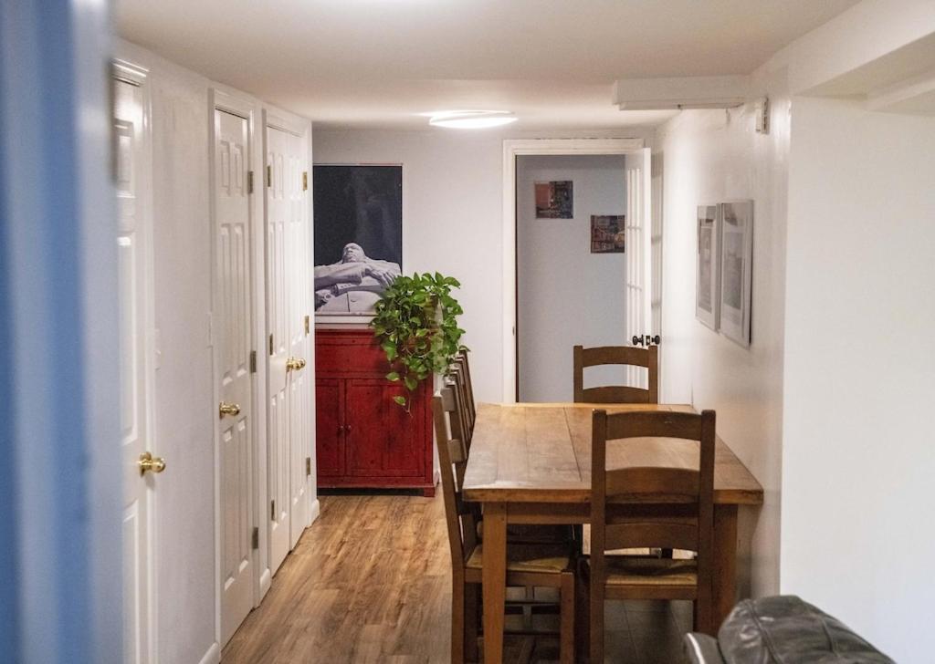 a dining room with a wooden table and a dining room table at 2 Bedroom by Zoo, Metro, Park and Embassies in Forest Hills - Best Location in Washington