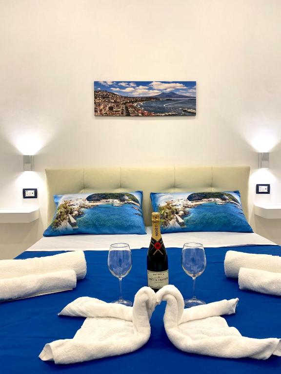 a bedroom with two beds with wine glasses and towels at Castellano apartment in Naples