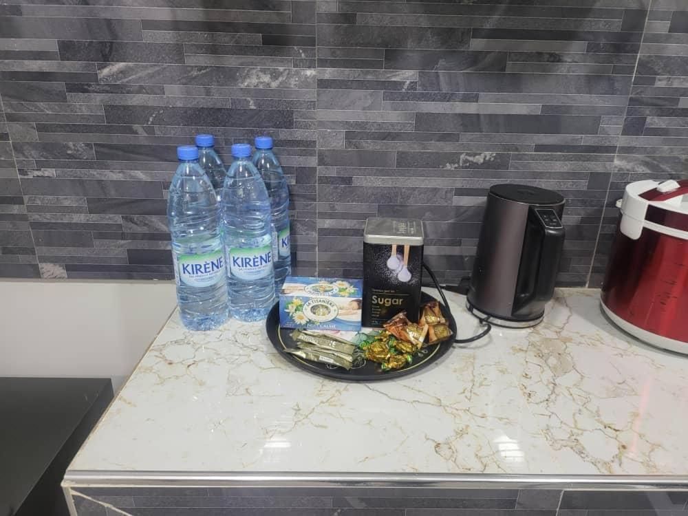 a plate of food and bottles of water on a counter at RESIDENCE TERANGA in Kammba