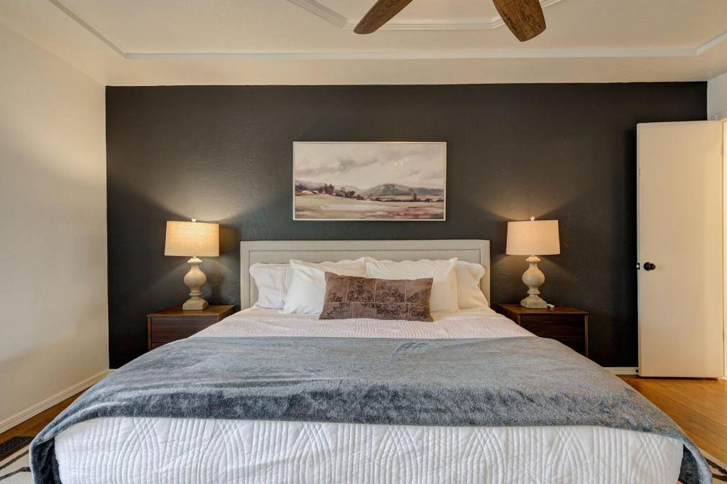 a bedroom with a large bed with two lamps at Family Home 5 Beds 3 Baths By Oc in Edmond