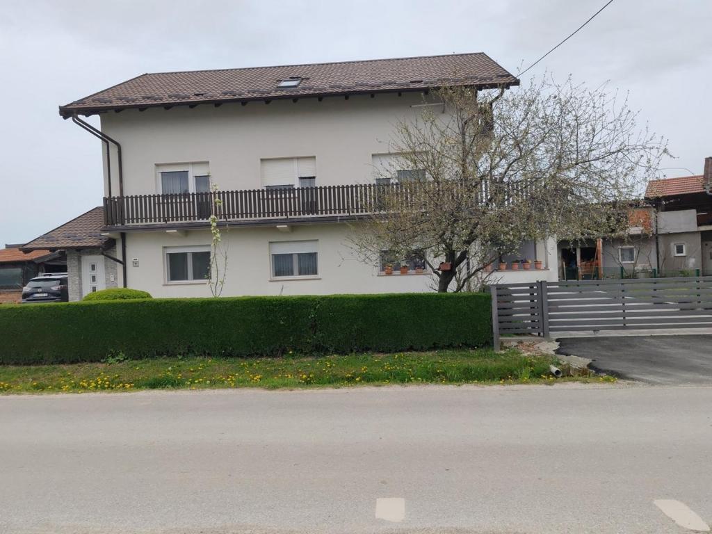 a white house with a balcony on top of it at Apartments with a parking space Vrbovec, Prigorje - 22922 in Vrbovec