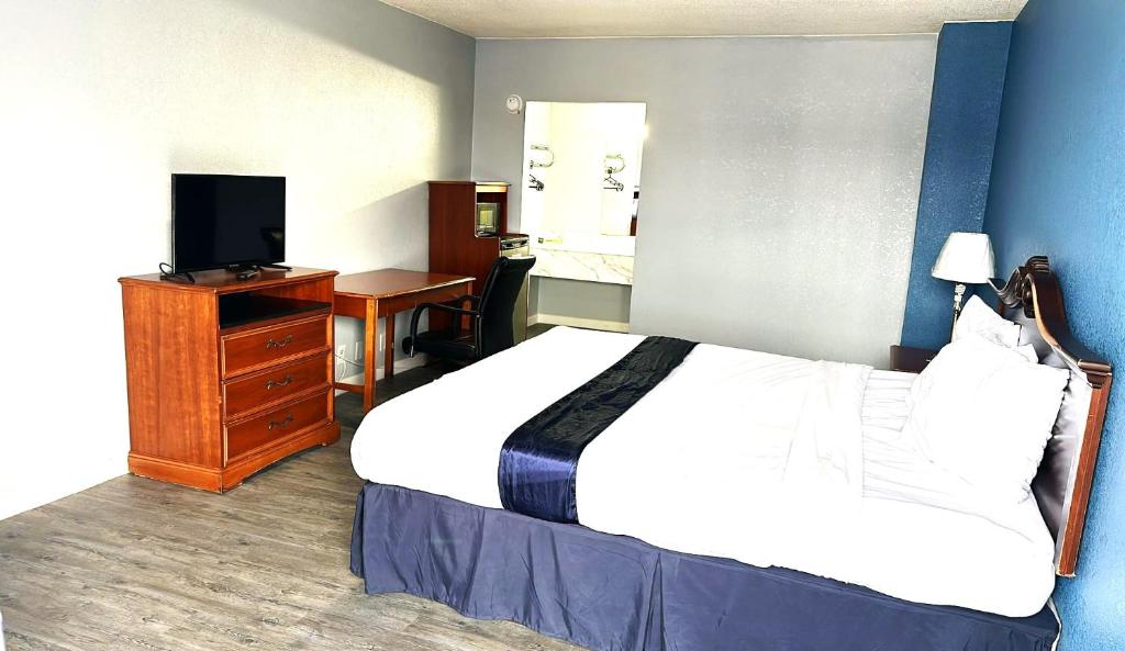 a hotel room with a bed and a television at Americas Best Value Inn Salisbury in Salisbury