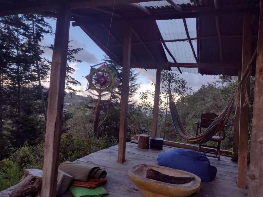 een kamer met een hangmat en uitzicht op de bergen bij Eco Aldea Cabaña entre helechos in Medellín