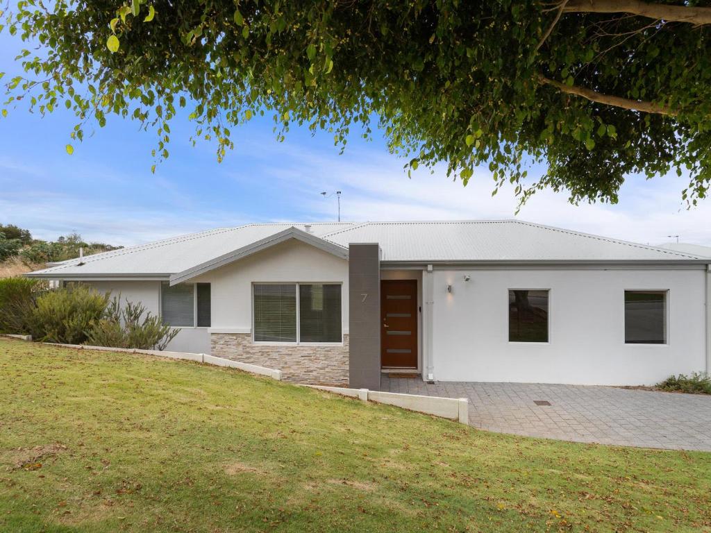 a white house with a yard at Three Bedroom, Two Bathroom Family Home in Coogee