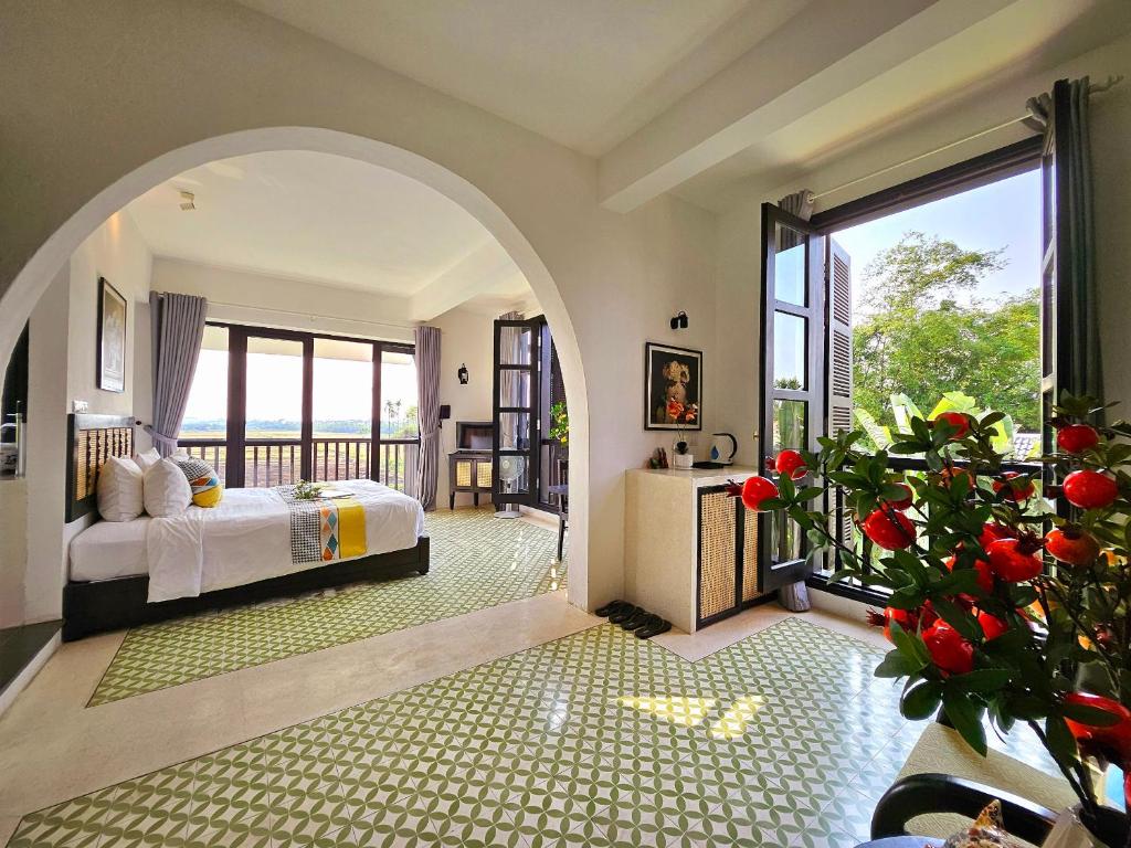 Postel nebo postele na pokoji v ubytování Nghé Garden Resort Hội An
