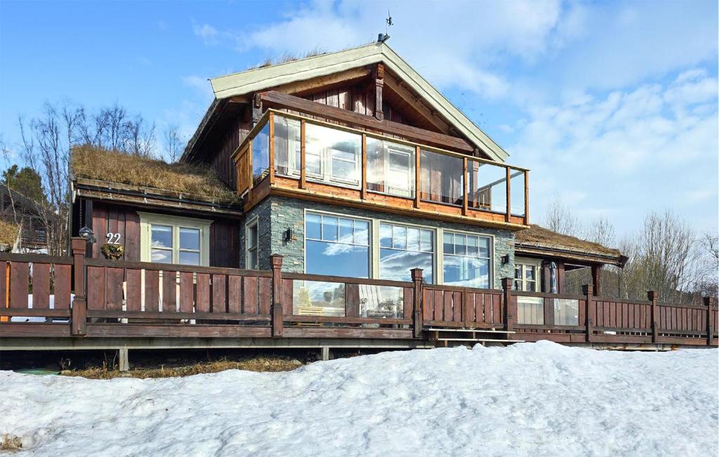 a house with a large deck in the snow at Beautiful Home In Oppdal With Kitchen in Oppdal