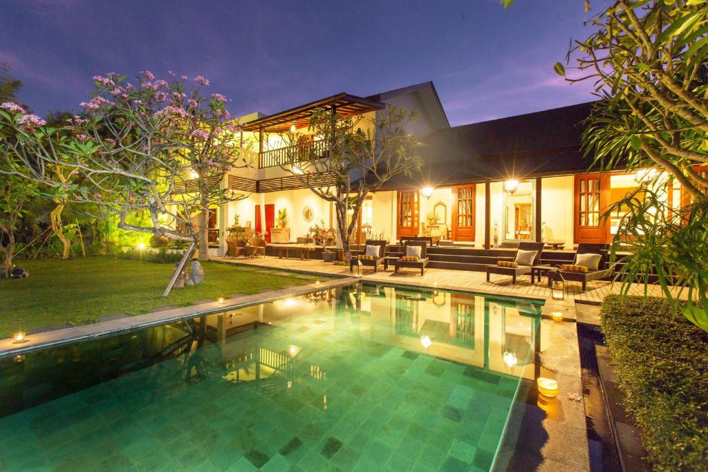a house with a swimming pool in the yard at Villa Balidamai by Nagisa Bali in Kerobokan