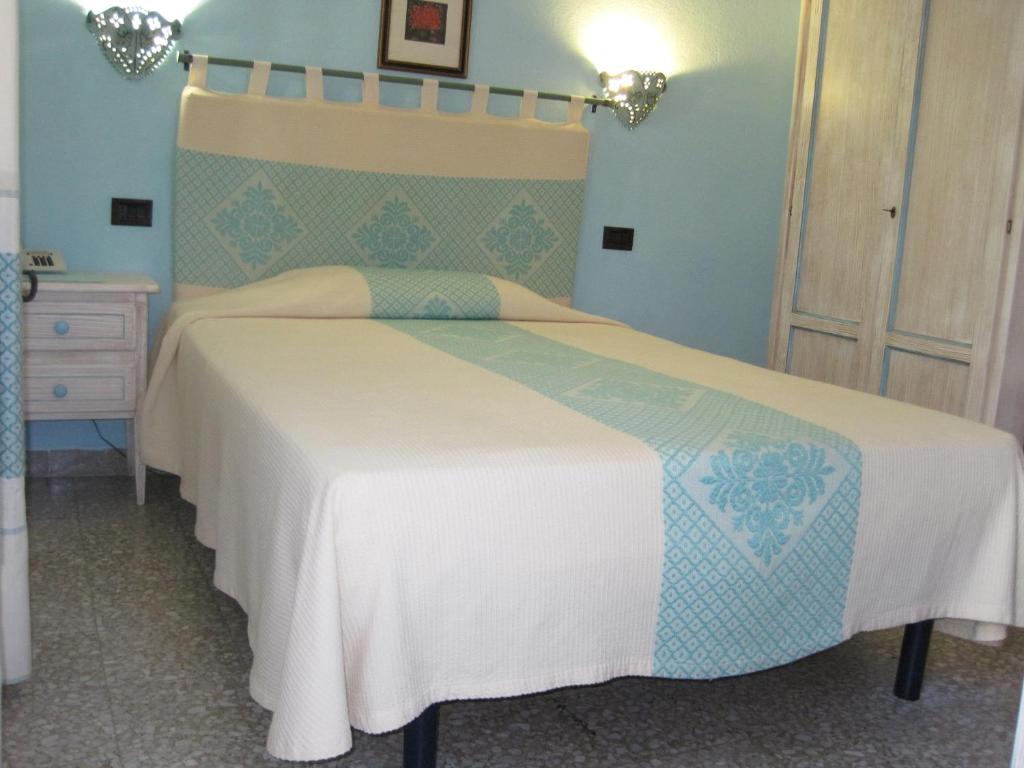 Łóżko lub łóżka w pokoju w obiekcie Hotel Moderno