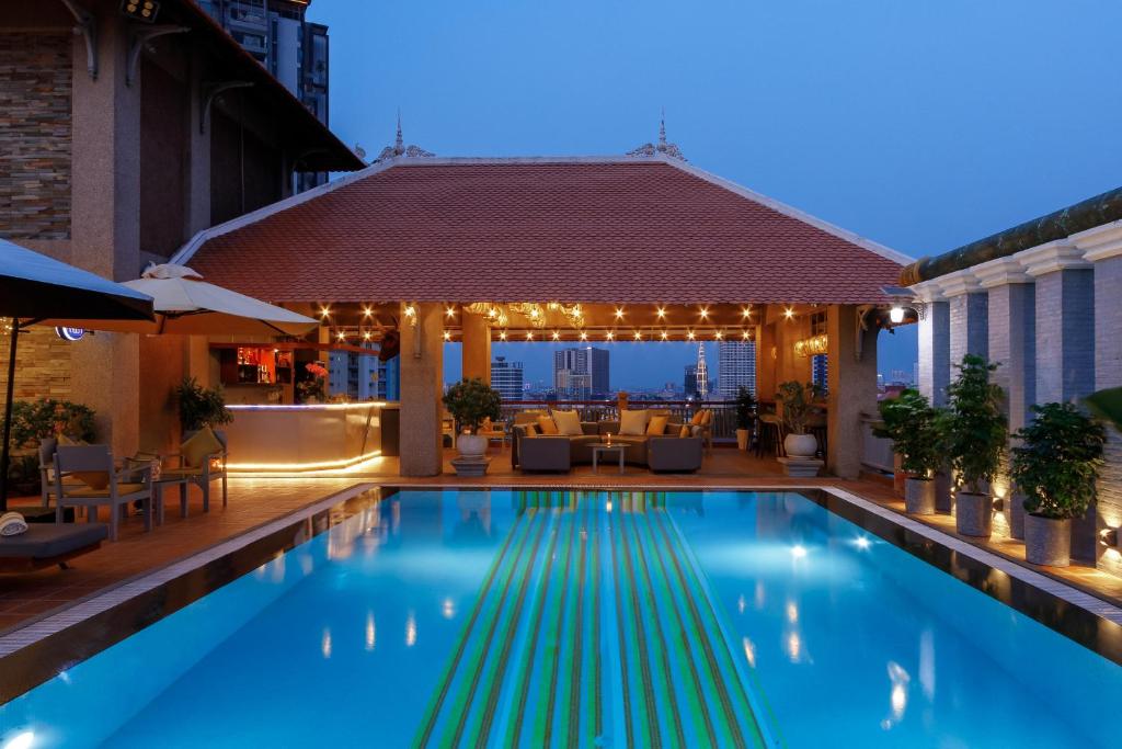 a swimming pool with lights on a building at Jaya Suites Hotel in Phnom Penh