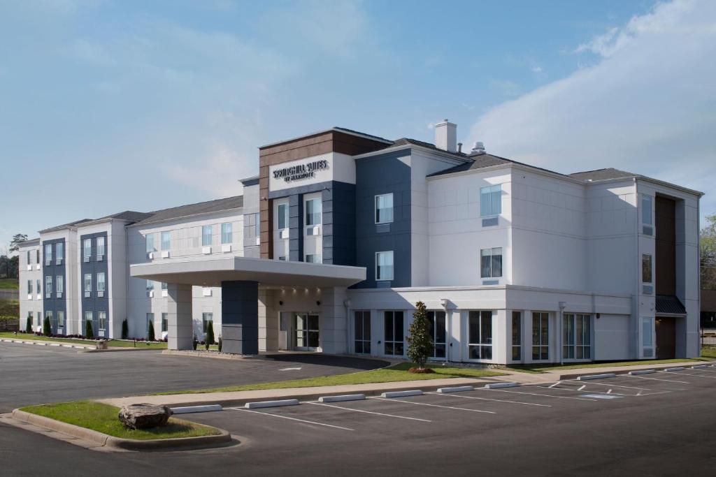 a large white building with a parking lot at SpringHill Suites by Marriott Little Rock in Little Rock