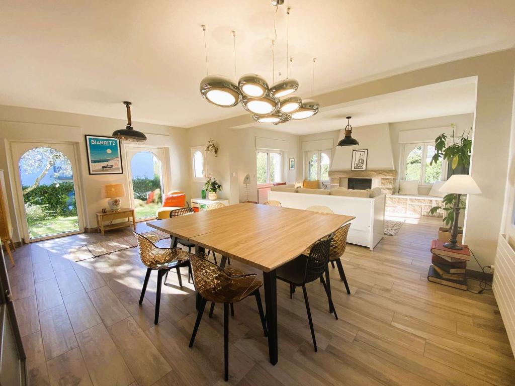 a kitchen and dining room with a wooden table and chairs at Maison 5 chambres à 150 m de la plage, rénovée, jardin, proche restaurants et commerces - FR-1-481-161 in Bénodet