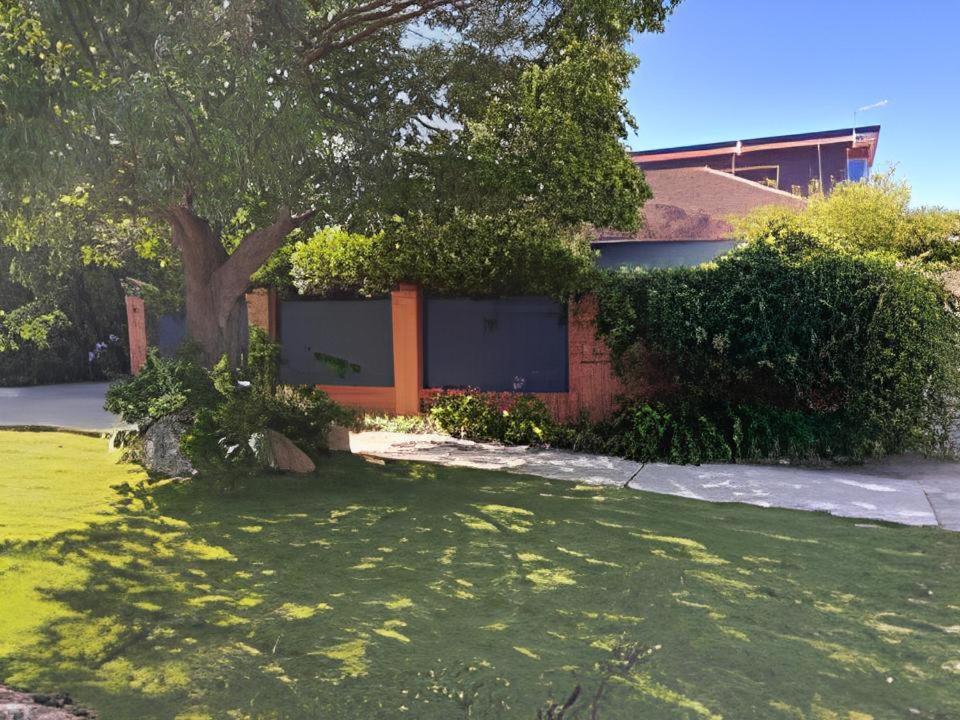 a house with a tree in the middle of a yard at Between the City and the Sea w/ King Size Bed in Perth
