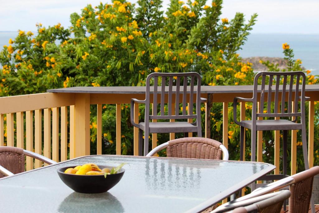 a bowl of fruit sitting on a table on a balcony at Encounter Bay Family Retreat in Encounter Bay