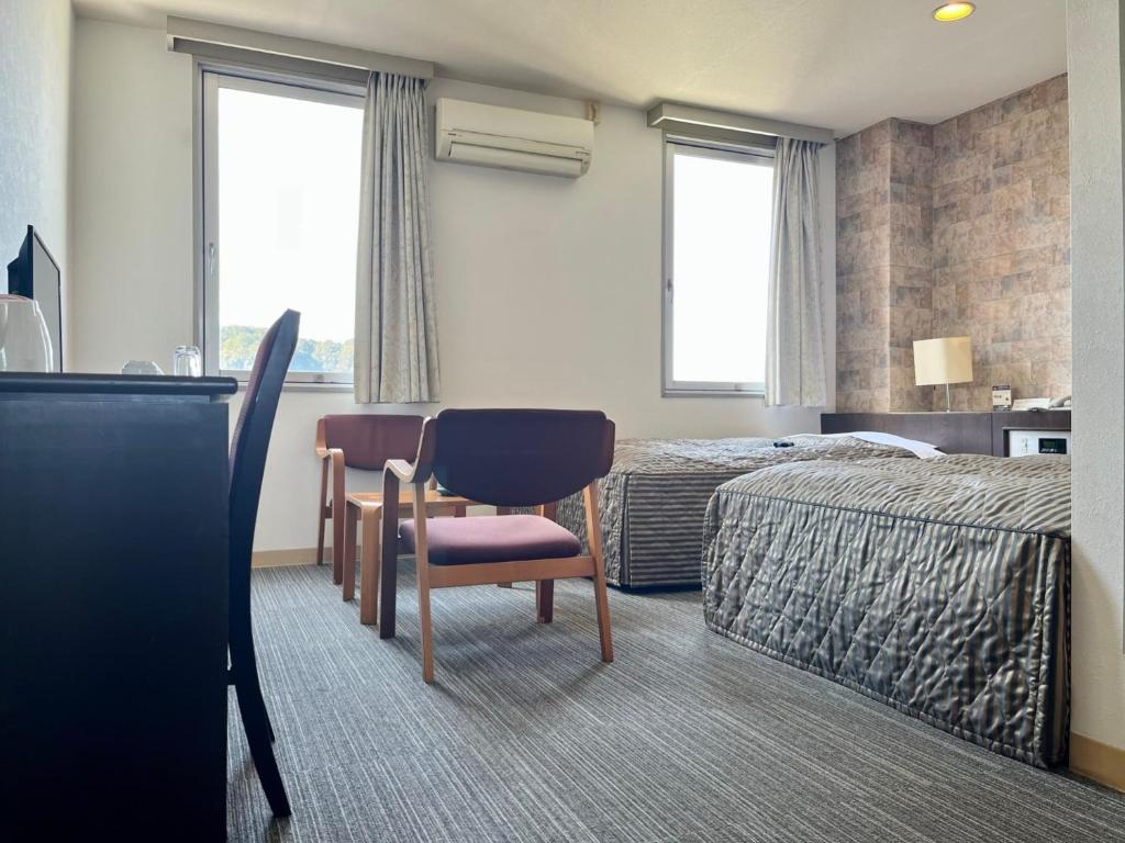 Postel nebo postele na pokoji v ubytování Nakamura Daiichi Hotel