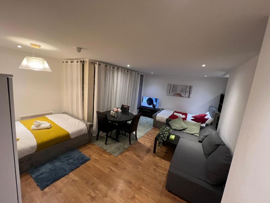 ロンドンにあるCanary Wharf O2 Arena Excel Londonのベッドルーム1室(ベッド1台、ソファ、テーブル付)