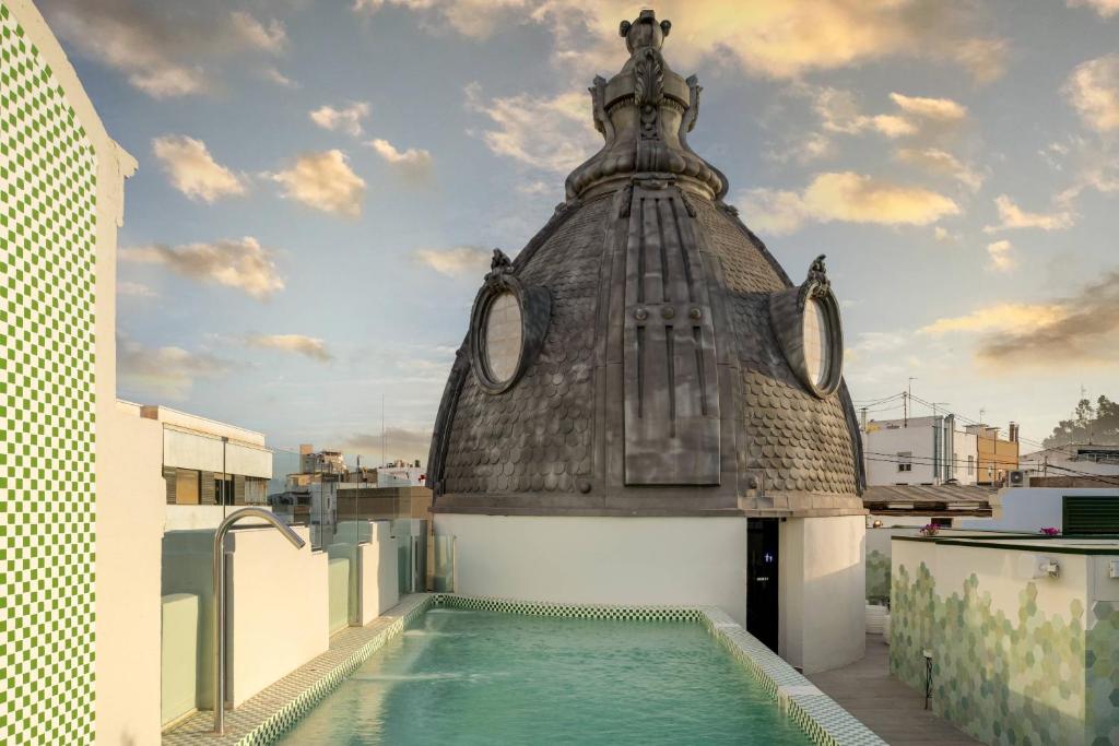 a building with a swimming pool on the roof at Palacio Santa Clara, Autograph Collection in Valencia