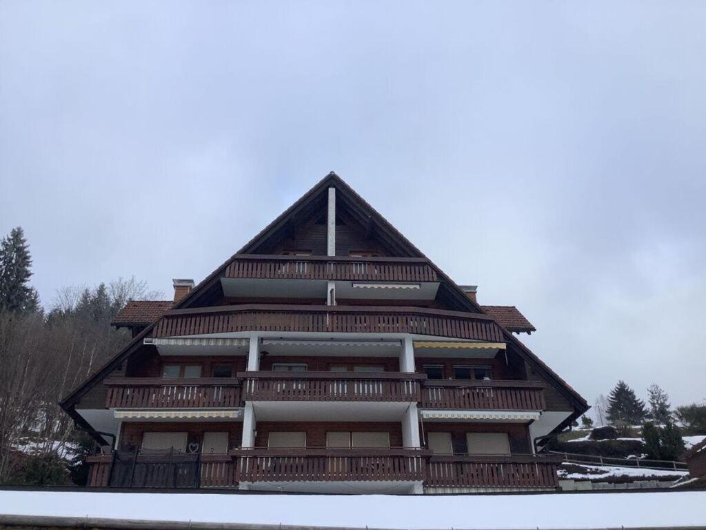 a large wooden building with a gambrel roof at Vakantieappartement Evi in Lenzkirch