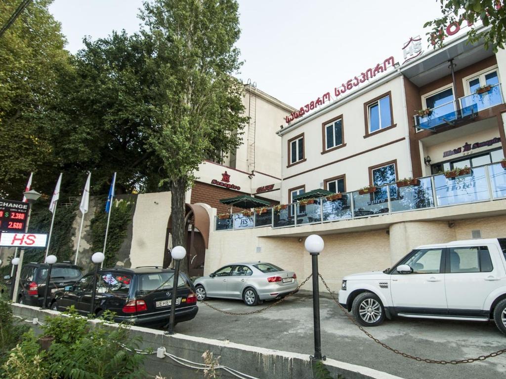 a group of cars parked in front of a building at Hotel Sanapiro Tbilisi in Tbilisi City