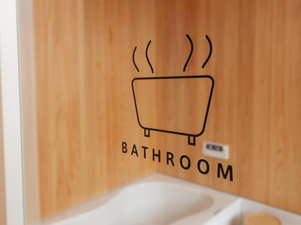 a door with a bathroom sign on the wall at A-UN lNN 会津若松 人気観光地へ車で10分 in Aizuwakamatsu
