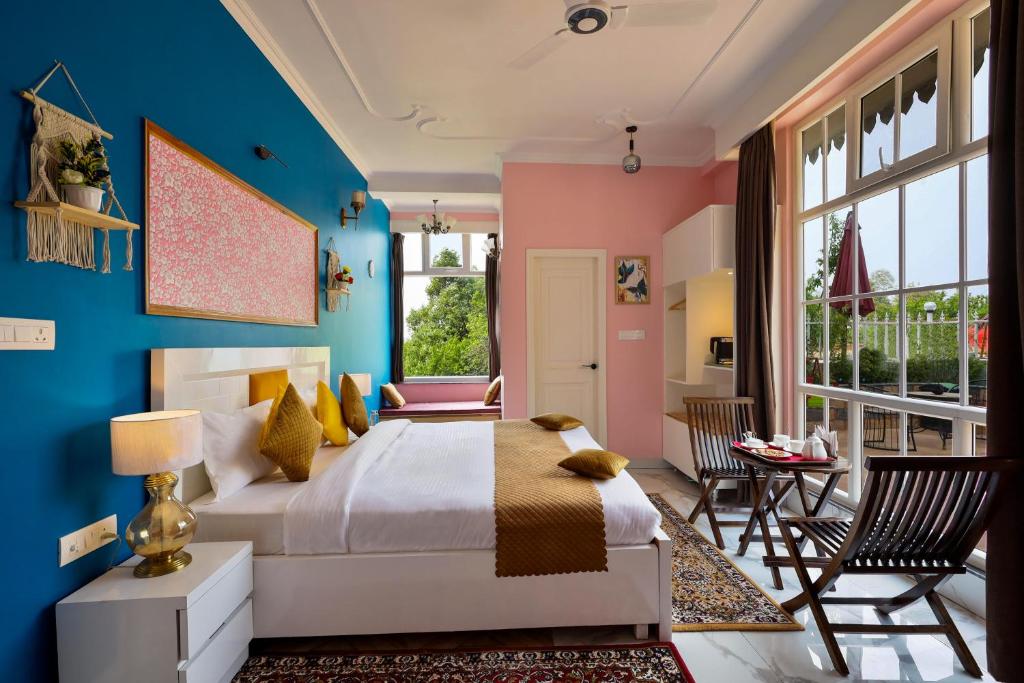 a bedroom with blue and pink walls and a bed at The Crosswoods Three in Mukteswar
