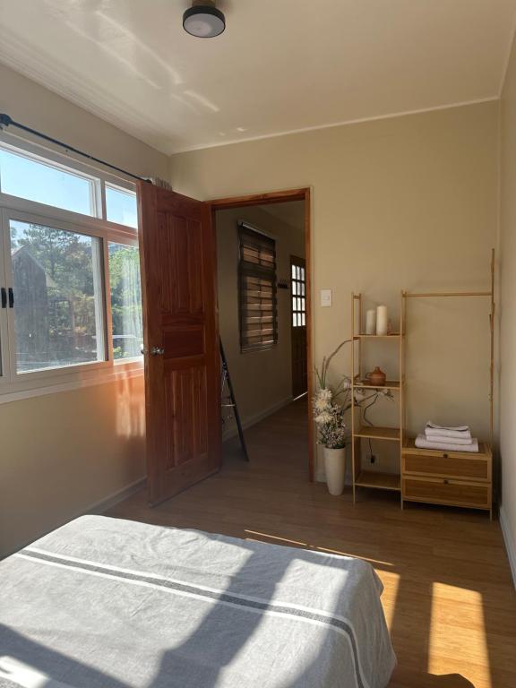 a bedroom with a bed and a large window at Riverside 2bed cozy apartment in La Trinidad