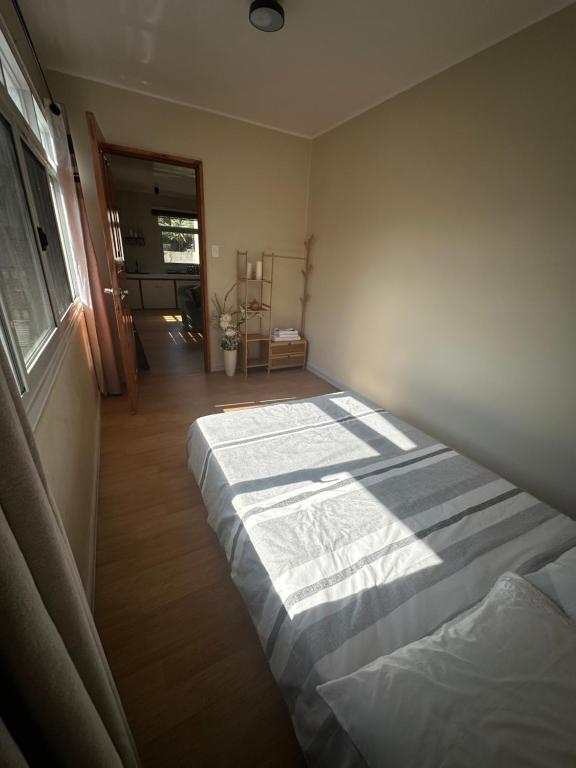 a bedroom with a bed in the corner of a room at Riverside 2bed cozy apartment in La Trinidad