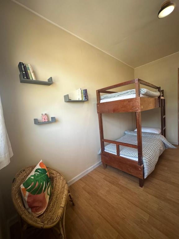 a room with a bunk bed and a chair at Riverside 2bed cozy apartment in La Trinidad
