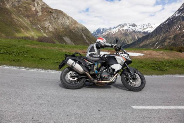 a person riding a motorcycle on a road at Gasthof Rieder Stubn in Ried im Oberinntal