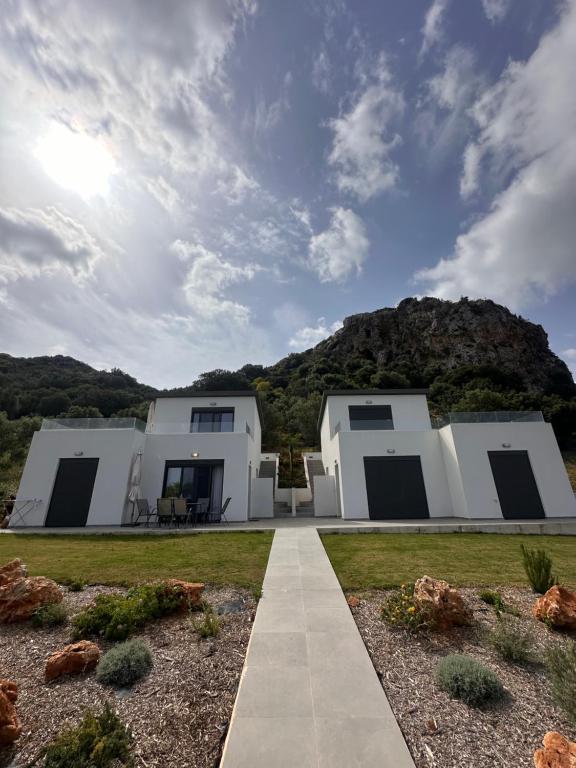 a white house with a mountain in the background at Luxury Villas In Nopigia With A Private Pool - Isabel Artemis in Nopíyia