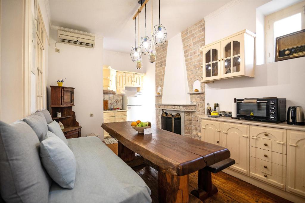 a living room with a couch and a table at Apeiron Acropolis Suites in Athens