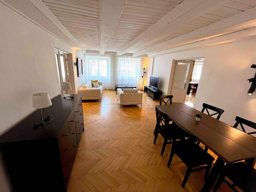 a large living room with a table and a couch at Kristian's Old Town Sq. Apartments in Prague