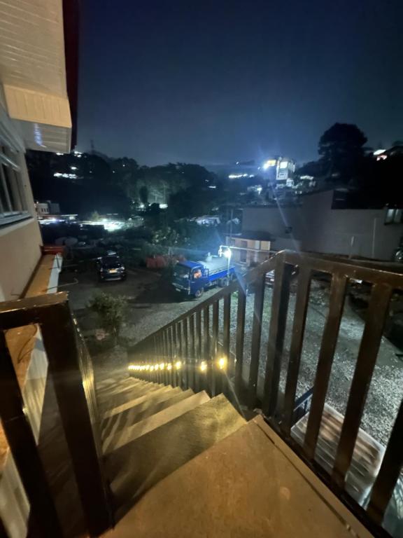 a balcony with a view of a parking lot at night at Riverside 2bed cozy apartment in La Trinidad