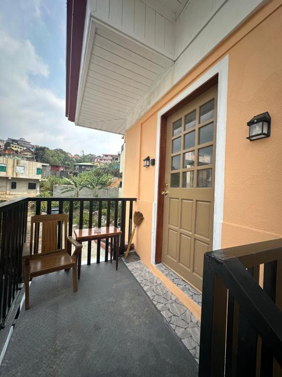 a porch with a door and benches on a balcony at Riverside 2bed cozy apartment in La Trinidad