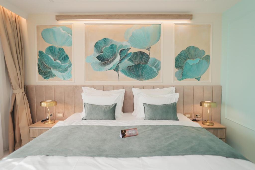 a bedroom with a bed with blue flowers on the wall at Hotel Bernarda in Varaždinske Toplice