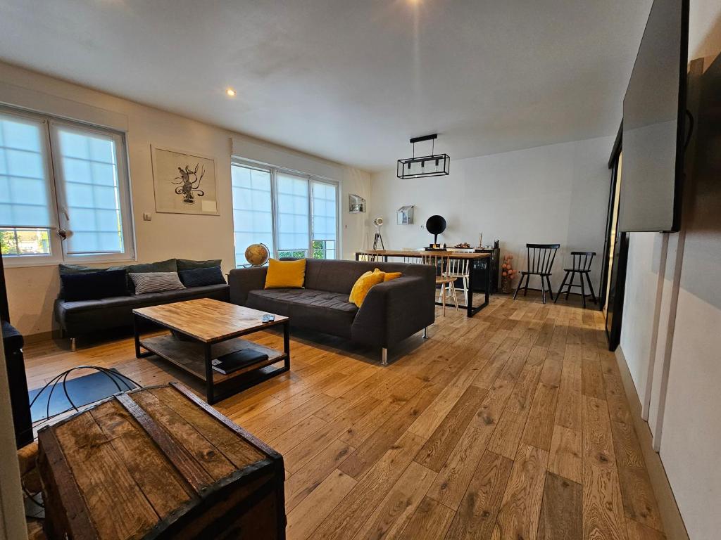 a living room with a couch and a table at La Bretèche in Saint-Martin-le-Beau