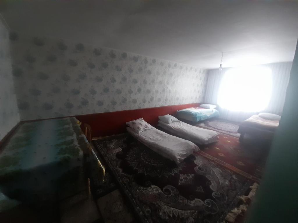 a room with two beds and a window at Xinaliq BedBreakfast in Quba