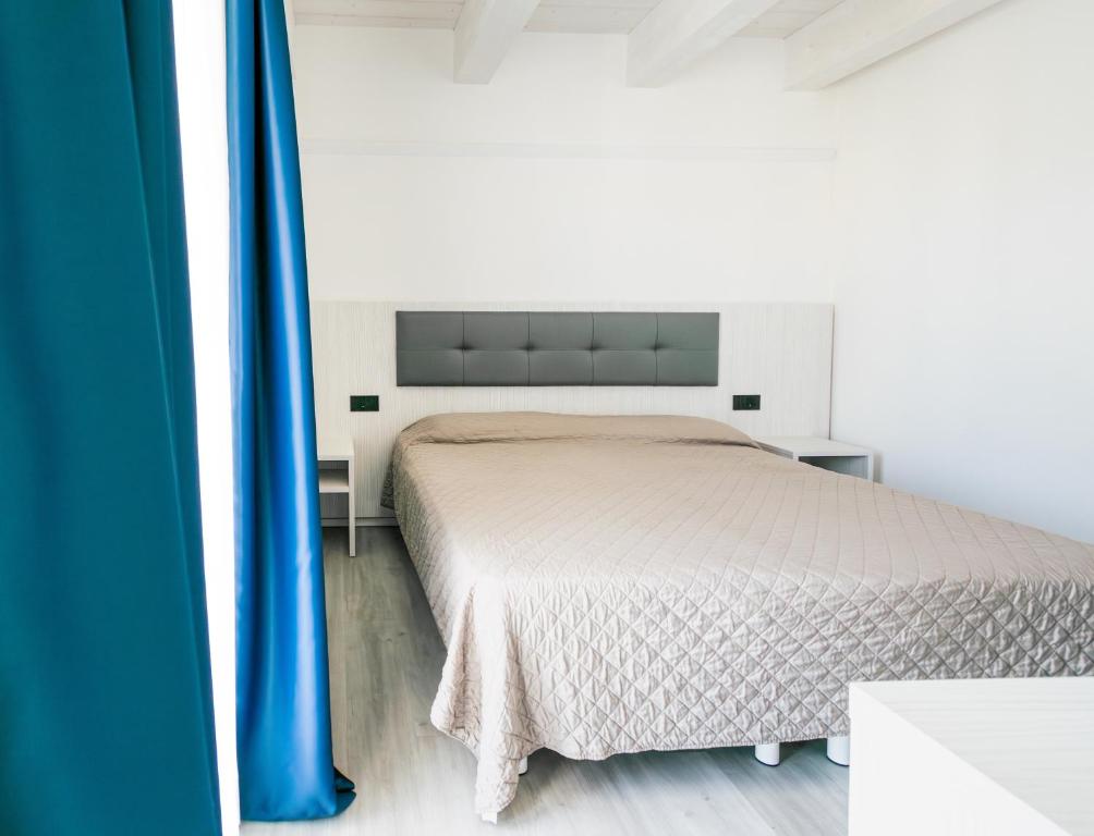 Postel nebo postele na pokoji v ubytování Hotel Giulio Cesare